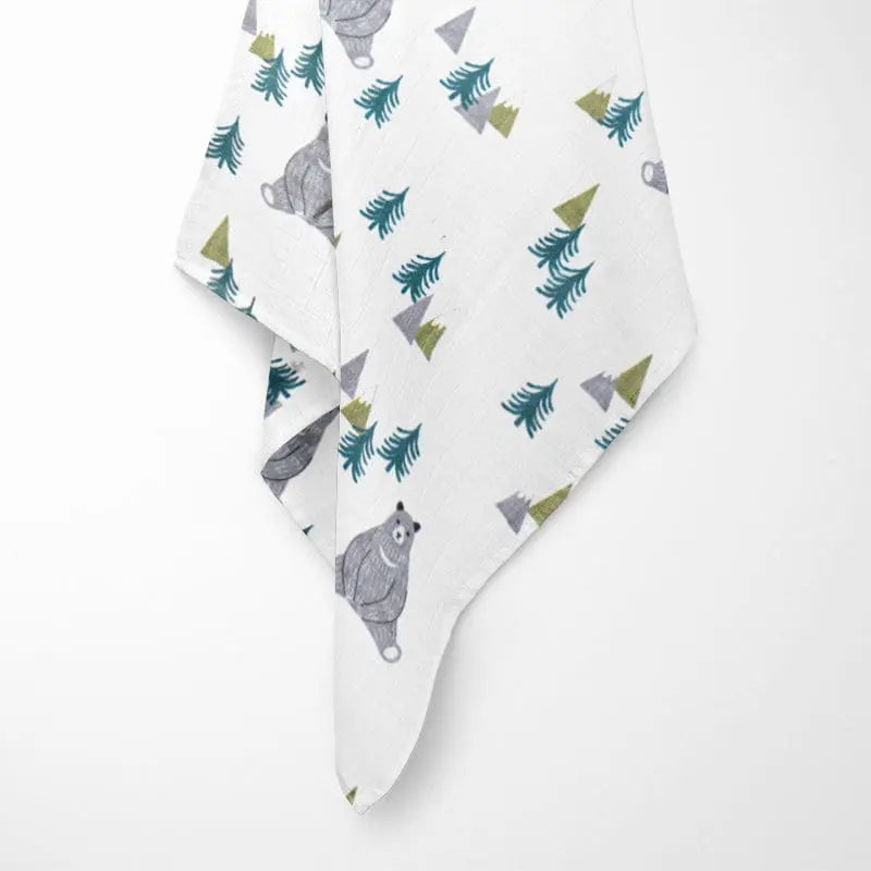 bear in forest bamboo baby blanket held up showing full pattern with cute bears, trees, and mountains on breathable organic fabric