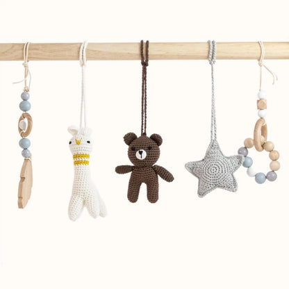 Close-up of Bear and Lama Play Gym toys showing detailed brown bear, white lama with yellow details, grey star and blue beaded accessories