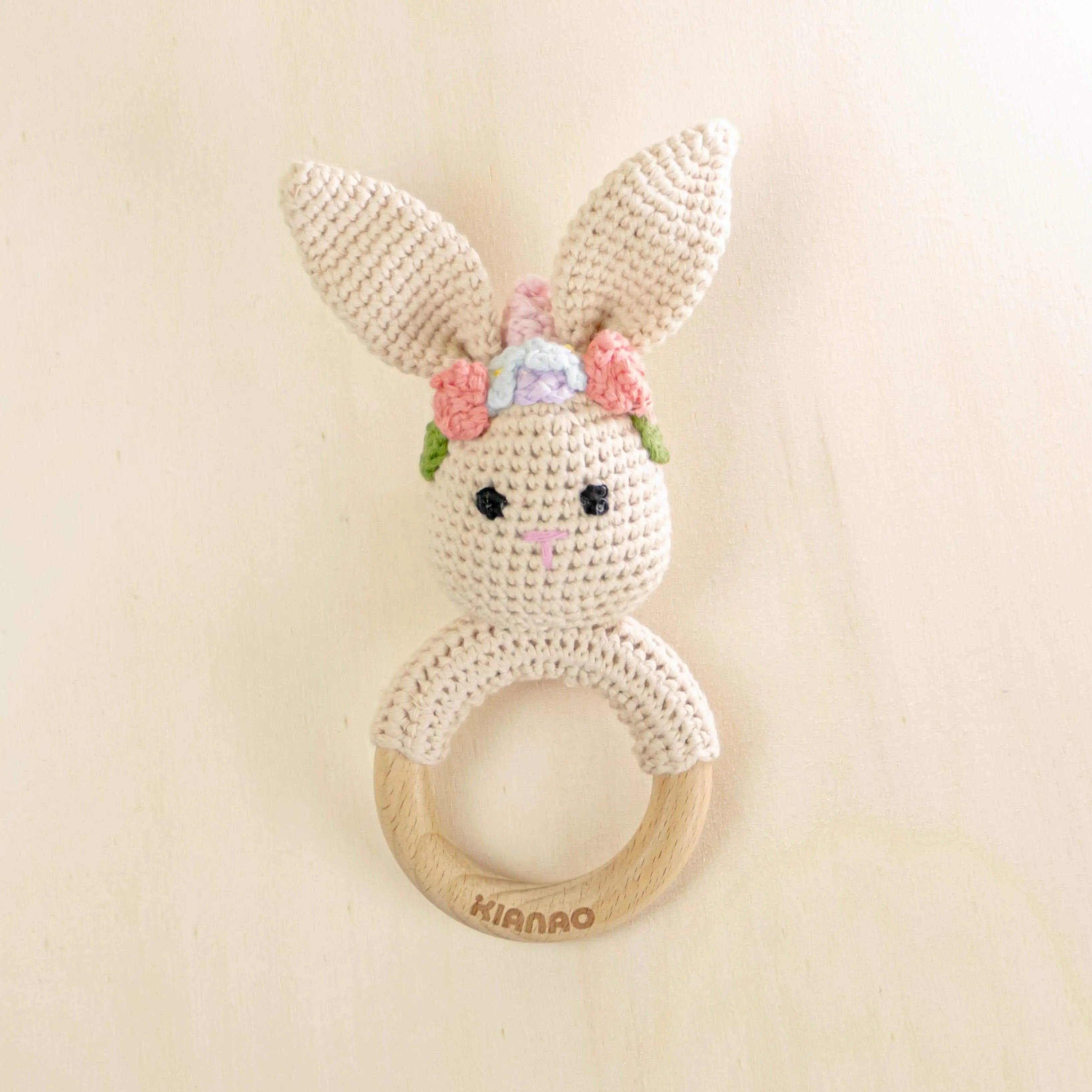beige crochet bunny teething rattle with wooden ring and pink flower crown, handmade baby teether toy
