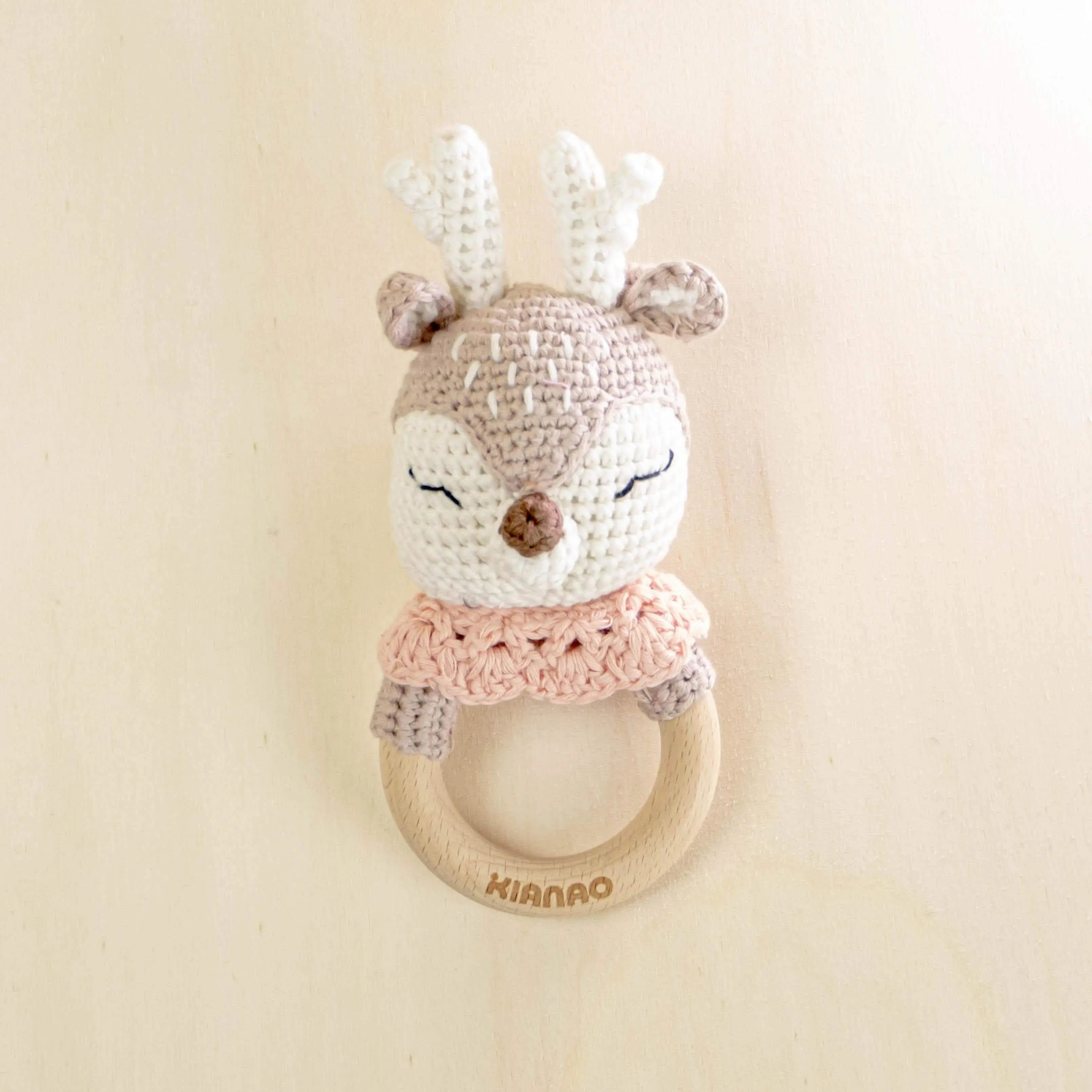 beige crochet deer teething rattle with pink bib and wooden ring, handmade baby teether toy with antlers