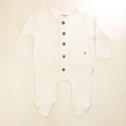blossom white organic cotton baby romper with footed design, front button closure and two practical pockets for infants