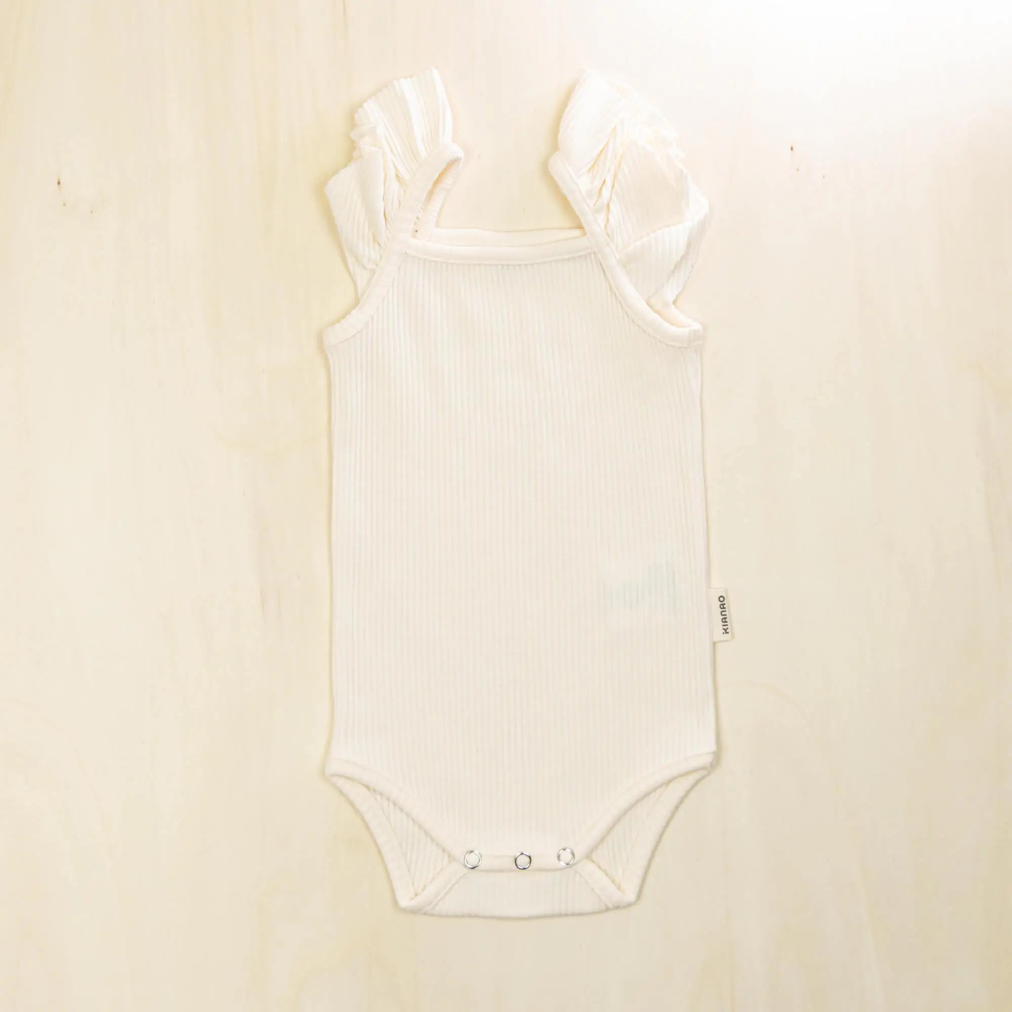 blossom white flutter sleeve organic cotton baby bodysuit with ruffled cap sleeves and comfortable fit