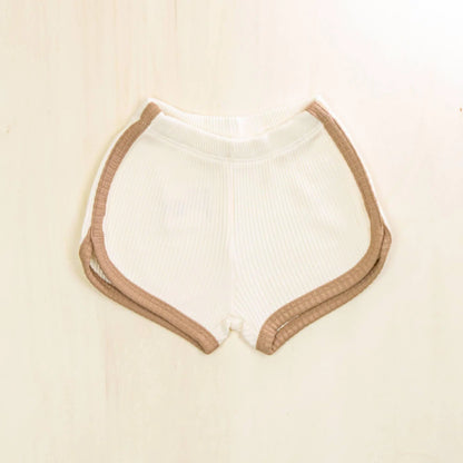 blossom white organic cotton baby shorts with contrasting trim, soft ribbed texture gentle on sensitive skin