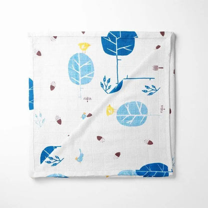 folded bamboo baby blanket featuring Scandinavian-inspired blue foxes and abstract leaves on white background with soft grid texture