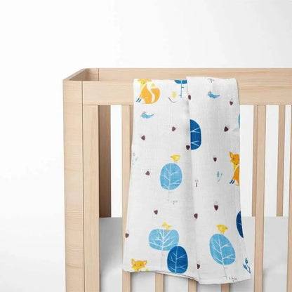 blue fox bamboo baby blanket displayed on wooden crib showing calming pattern that creates a serene sleep environment for babies