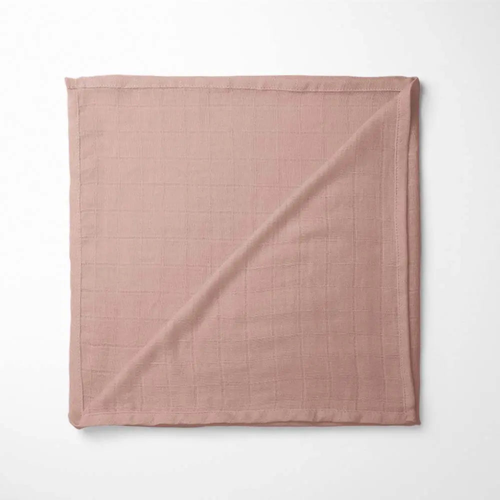 folded brick red bamboo baby blanket with soft grid texture, showing warm golden hue and organic fabric quality