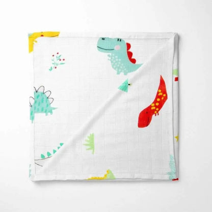 folded bamboo baby blanket featuring friendly turquoise and red dinosaurs on white background with soft grid texture