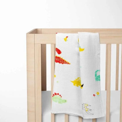 colorful dinosaur bamboo baby blanket displayed on wooden crib showing size and vibrant pattern perfect for stimulating visual development