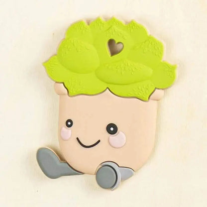 green silicone cactus baby teether with smiling face and beige pot design for soothing sore baby gums