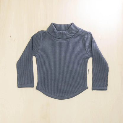 indigo blue organic cotton baby turtleneck sweater with curved hemline and long sleeves, soft sustainable fabric for sensitive skin