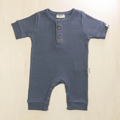 indigo blue organic cotton baby romper featuring convenient button-front design and soft breathable fabric