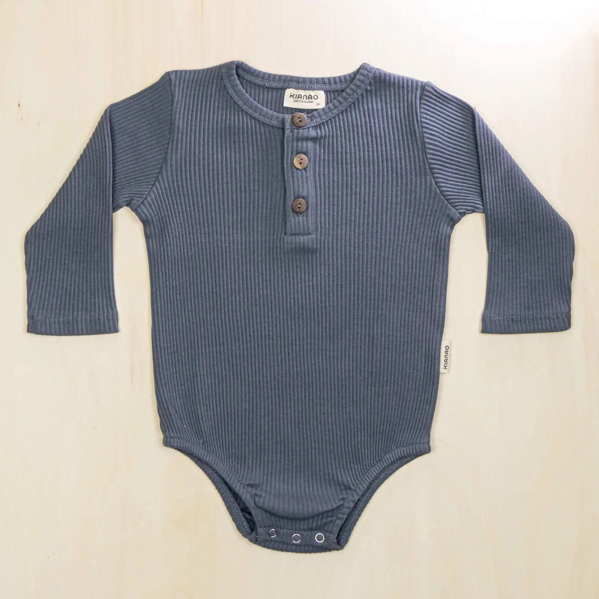 indigo blue organic cotton long sleeve romper with soft fabric gentle on baby's sensitive skin