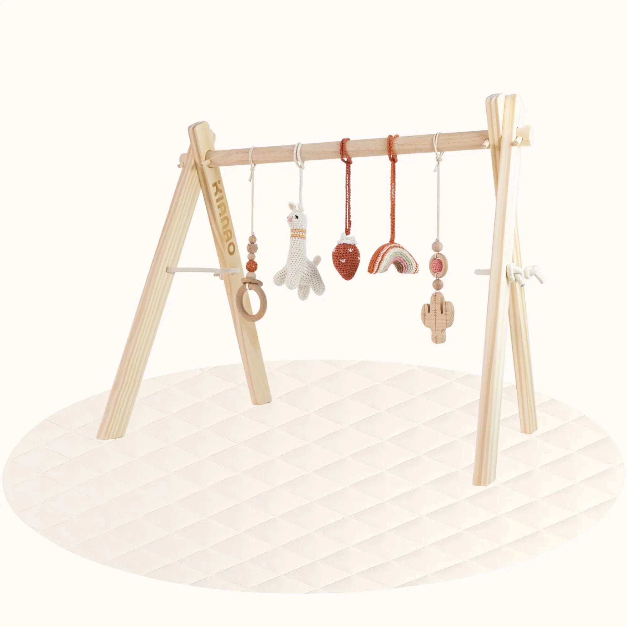 Side view of wooden Lama with Strawberry Play Gym showing A-frame structure with hanging desert-themed toys