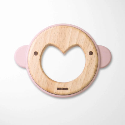 light pink silicone ear monkey baby teether with natural beechwood center and heart-shaped opening for easy grasping during teething