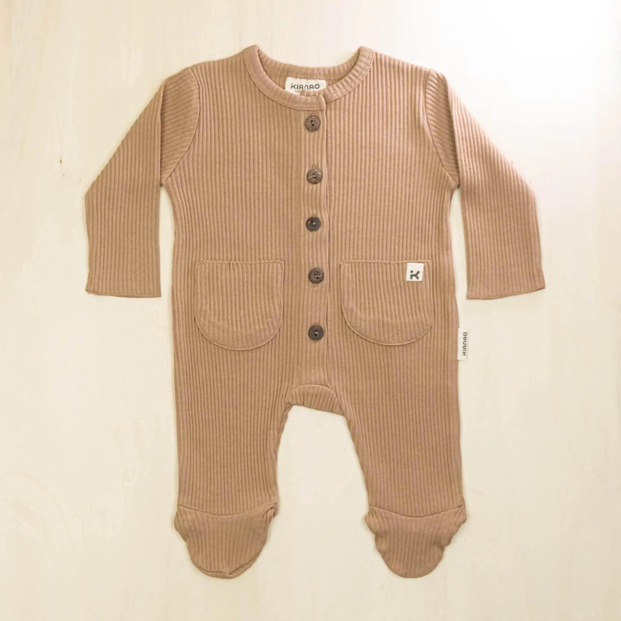 mocha organic cotton baby romper with integrated feet, full-length front buttons and twin pockets for comfortable all-day wear