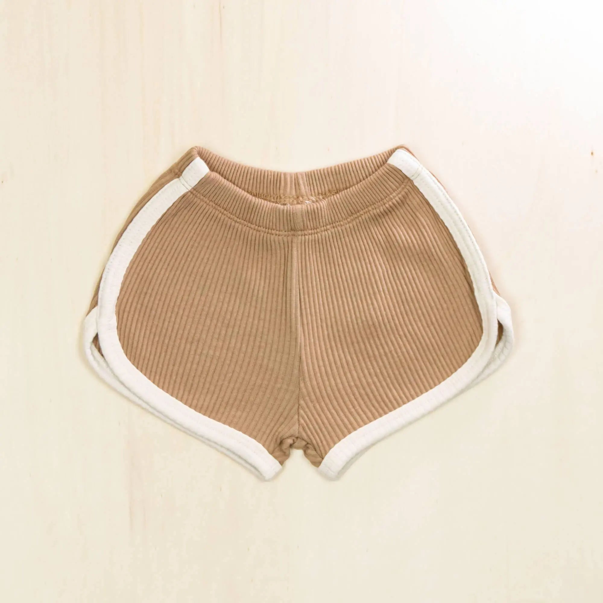 mocha organic cotton baby shorts with white trim and ribbed texture, retro athletic design for comfortable movement