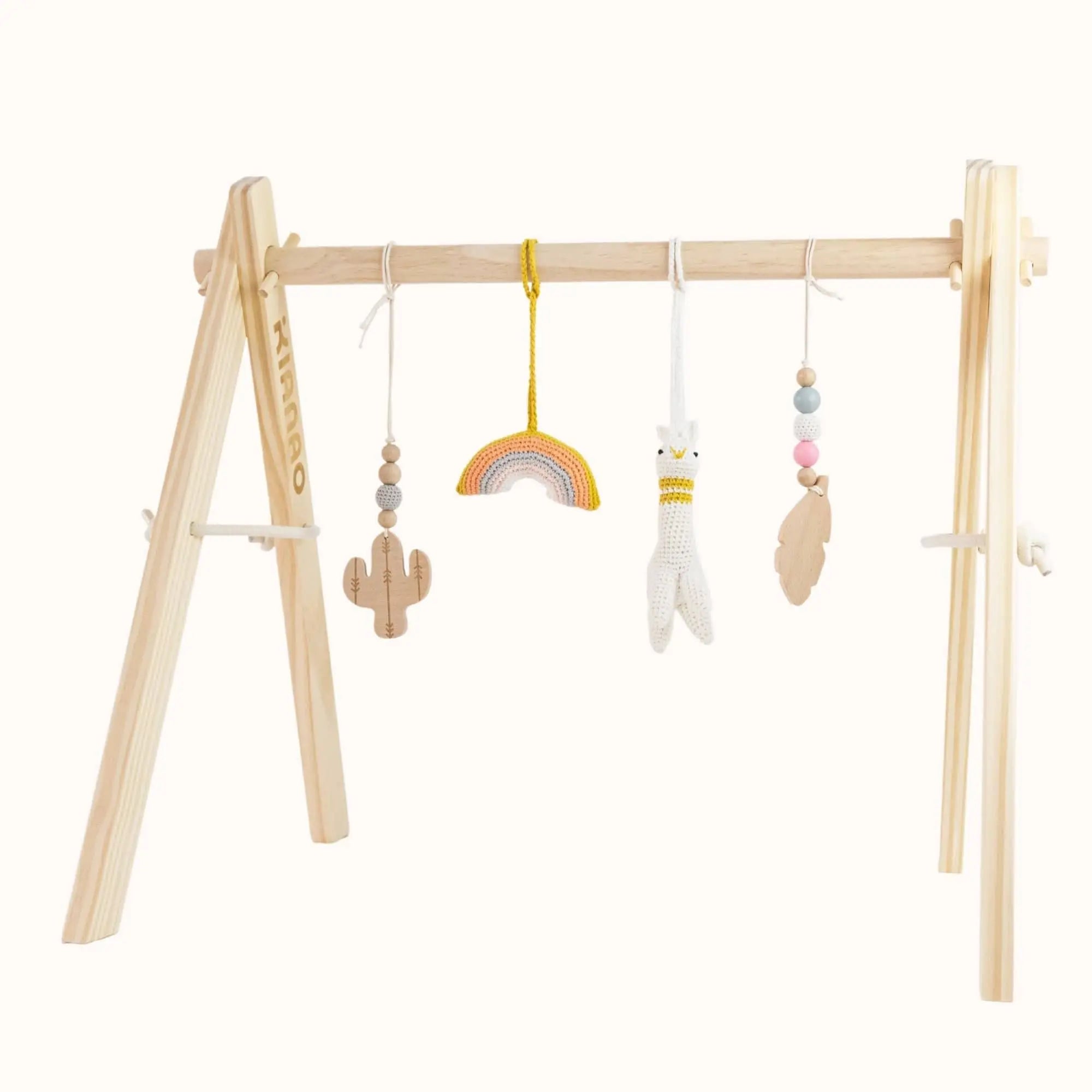 Natural wooden baby gym with hanging alpaca, rainbow, cactus and cloud toys on sturdy A-frame design for sensory play