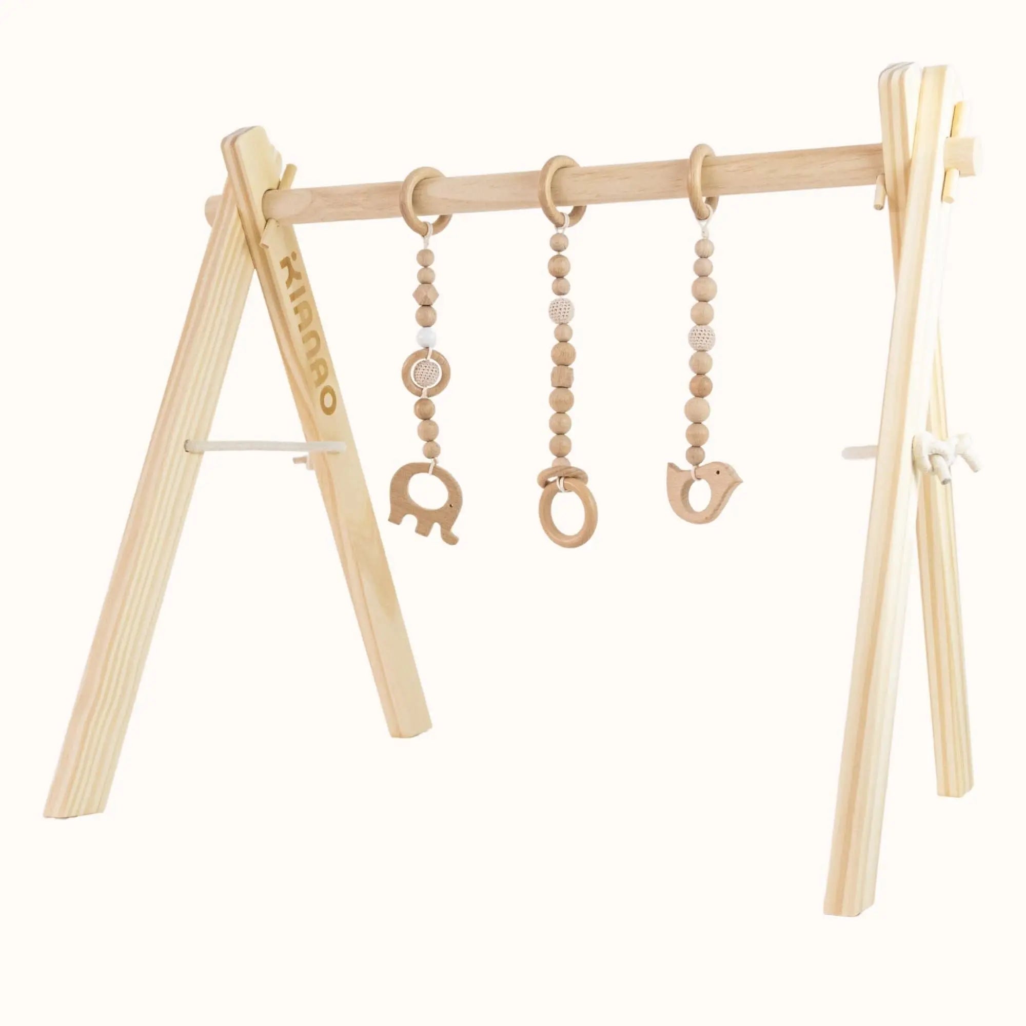 All-natural wooden baby gym with carved elephant, bird, and ring toys suspended from beaded strands on minimalist A-frame