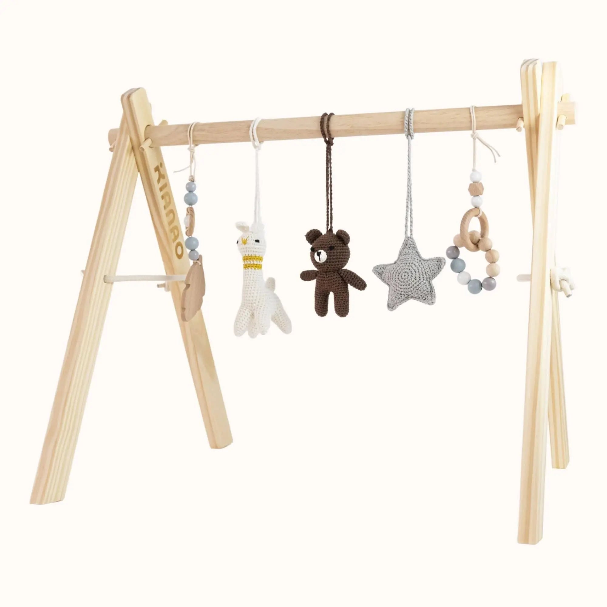 Natural wooden baby gym with handcrafted crochet toys including brown bear, white lama, grey star and beaded elements