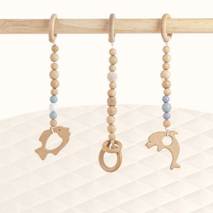 Front view of Fishs Play Gym with three wooden ring toys perfectly spaced for baby's reaching practice
