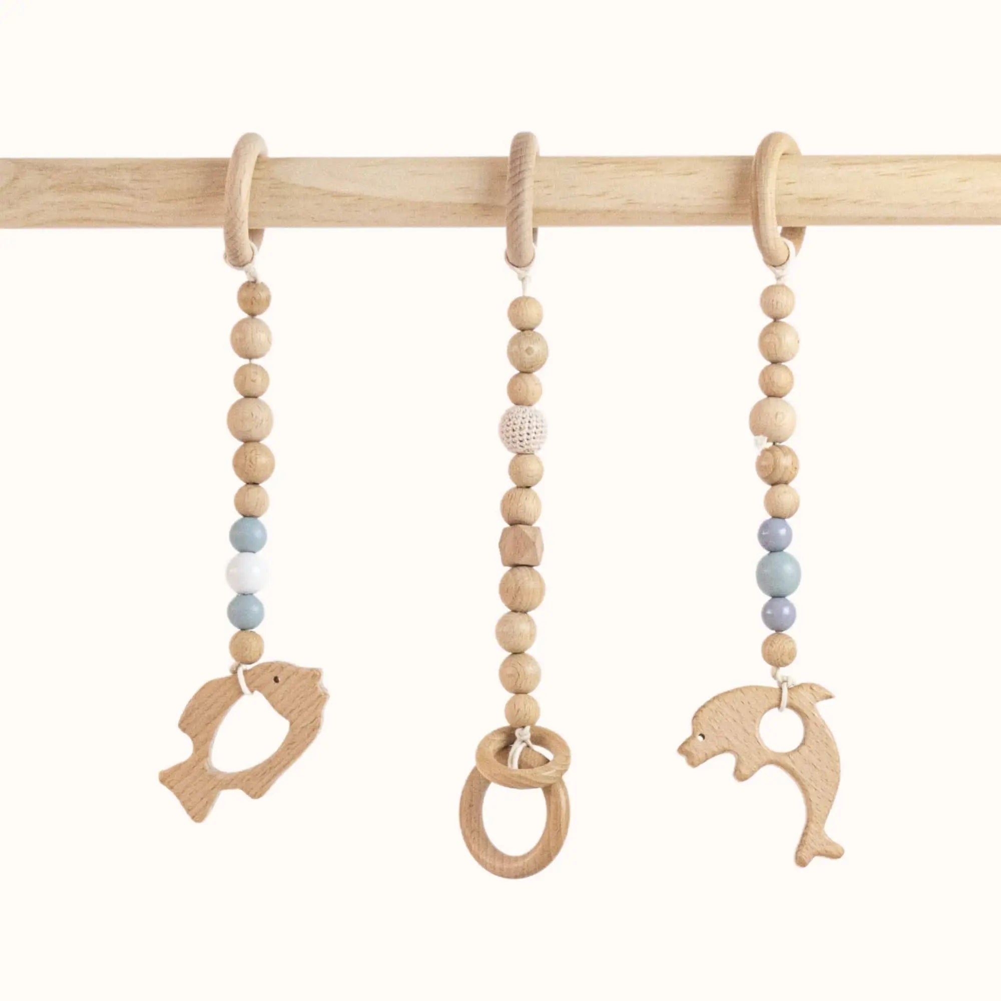 Close-up of Fishs Play Gym wooden ring toys showing smooth finish and natural grain for safe tactile exploration