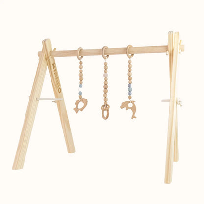 Natural wooden baby gym with hanging wooden ring toys on sturdy A-frame design for sensory play and motor skill development
