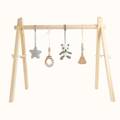 Natural wooden baby gym with grey crochet panda, star, wooden teepee and beaded ring toys on sturdy A-frame design