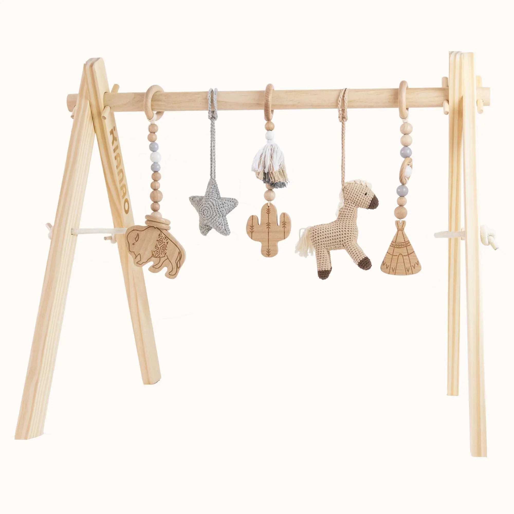 Natural wooden baby gym with southwestern-themed toys including wooden buffalo, crochet horse, star, cactus and teepee