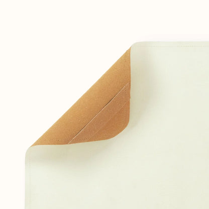 corner detail of oat cream baby play mat showing rounded edge and premium vegan leather texture