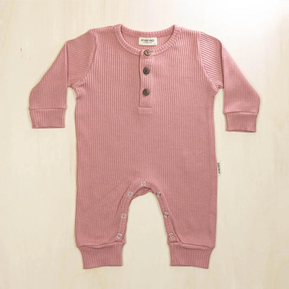 old rose organic cotton jumpsuit featuring three-button henley neckline and soft stretchable fabric