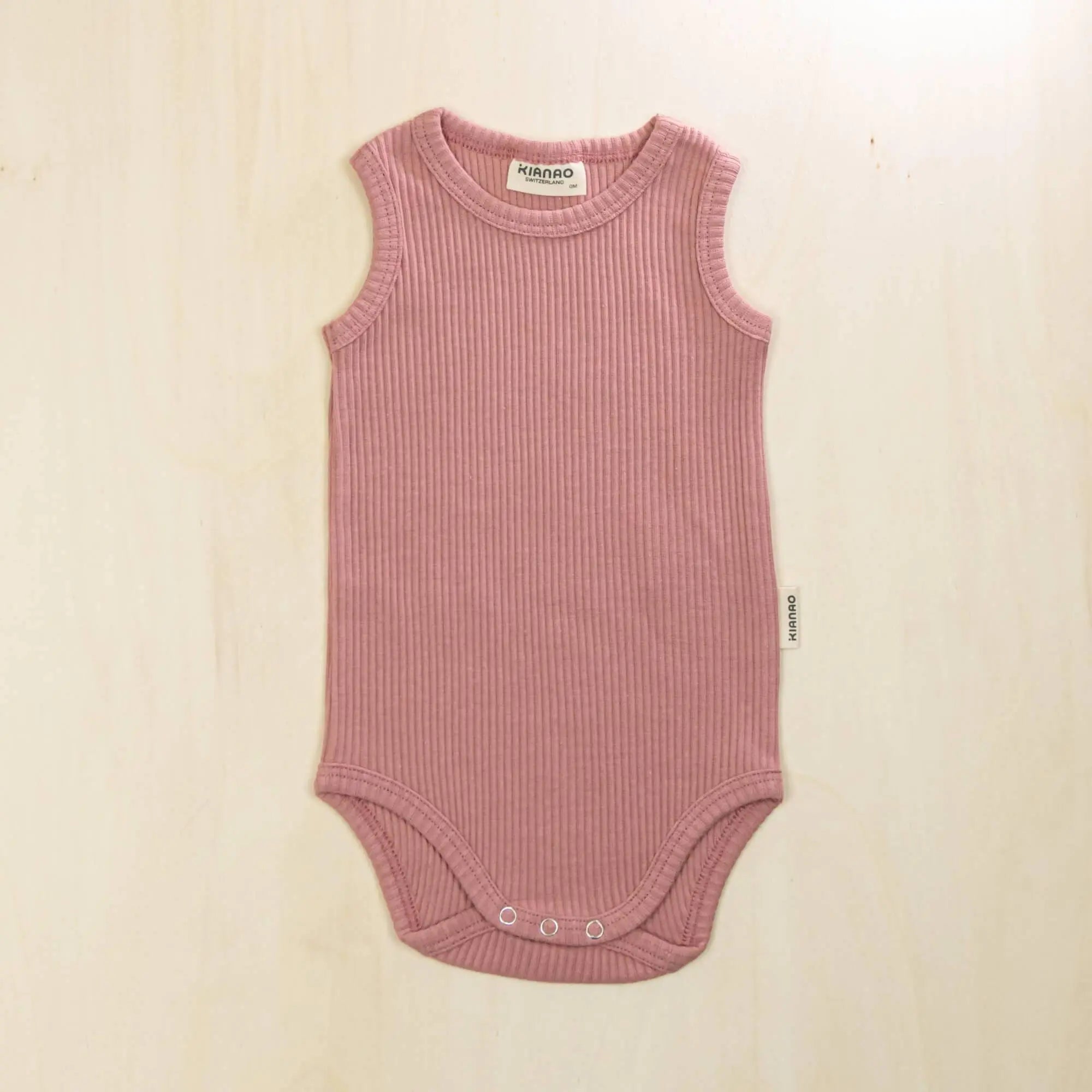 old rose organic cotton baby bodysuit with flat seams and tagless design to prevent skin irritation
