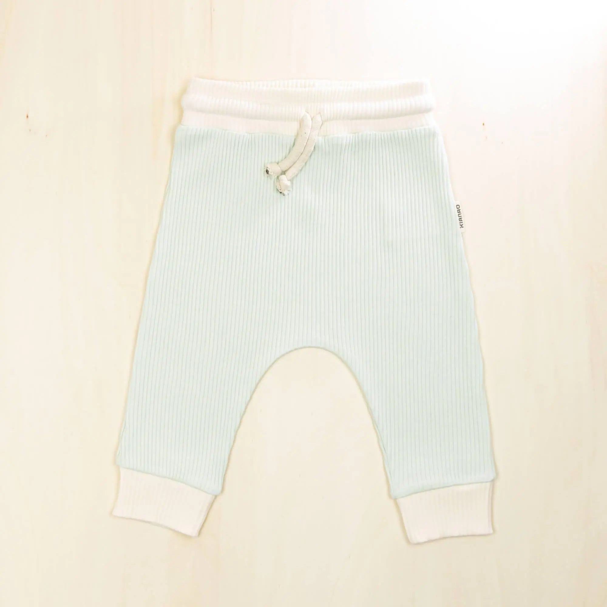 pale turquoise organic cotton baby pants with white trim, comfortable jogger style with adjustable drawstring waist