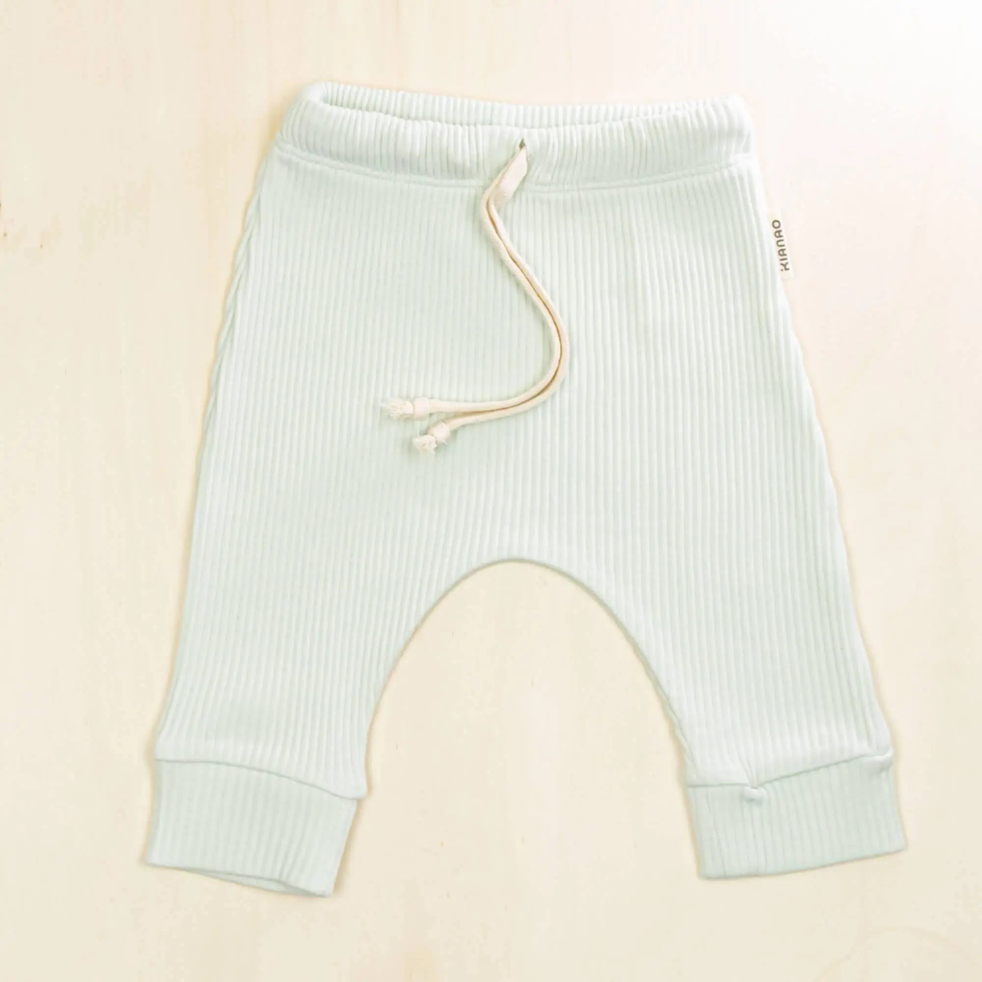 pale turquoise organic cotton baby pants with adjustable drawstring, ribbed texture and relaxed harem fit for comfort