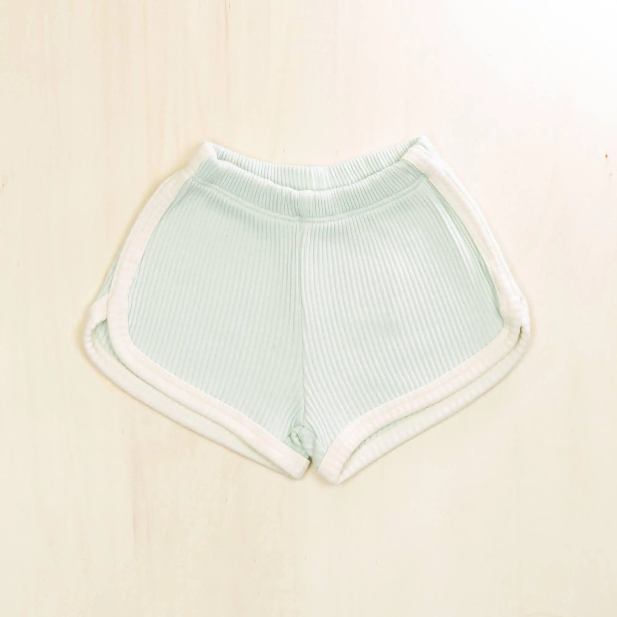 pale turquoise organic cotton baby shorts with white trim detailing, ribbed texture for active babies and toddlers
