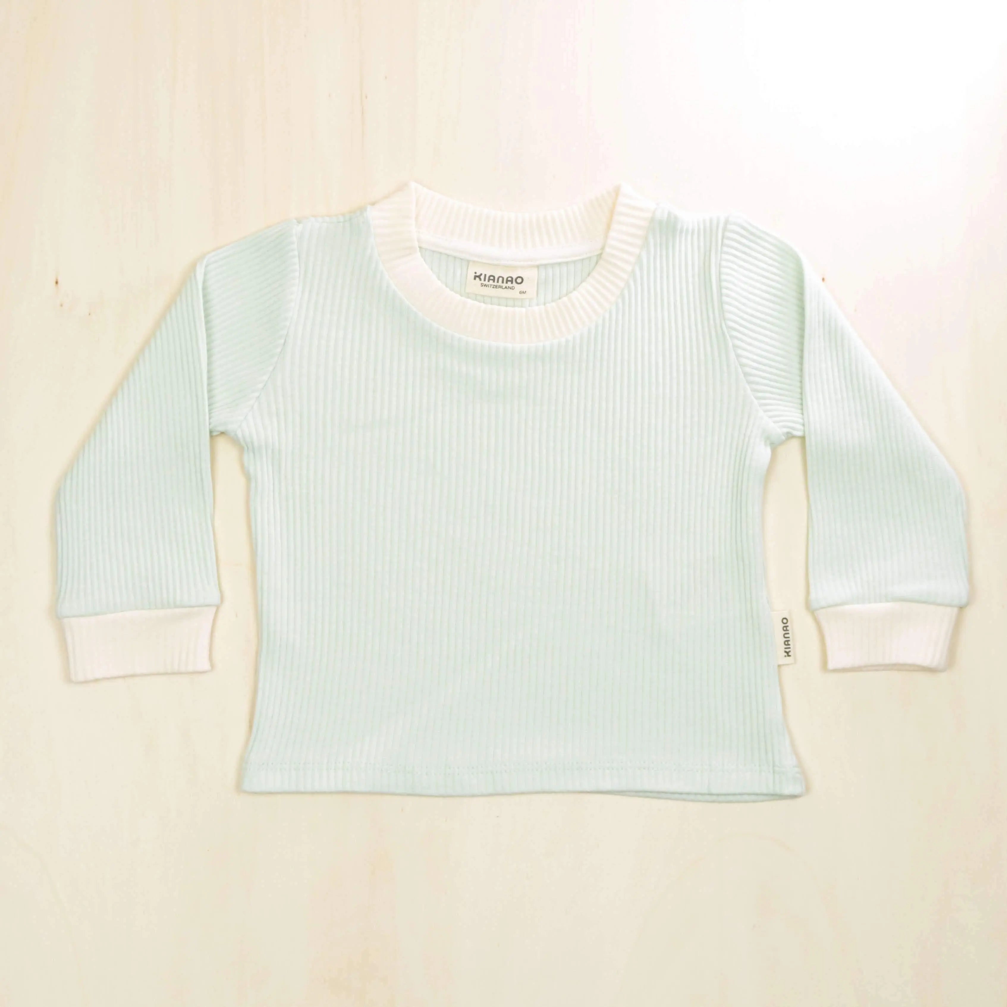 pale turquoise organic cotton baby sweater with white trim detailing, retro design perfect for layering in all seasons