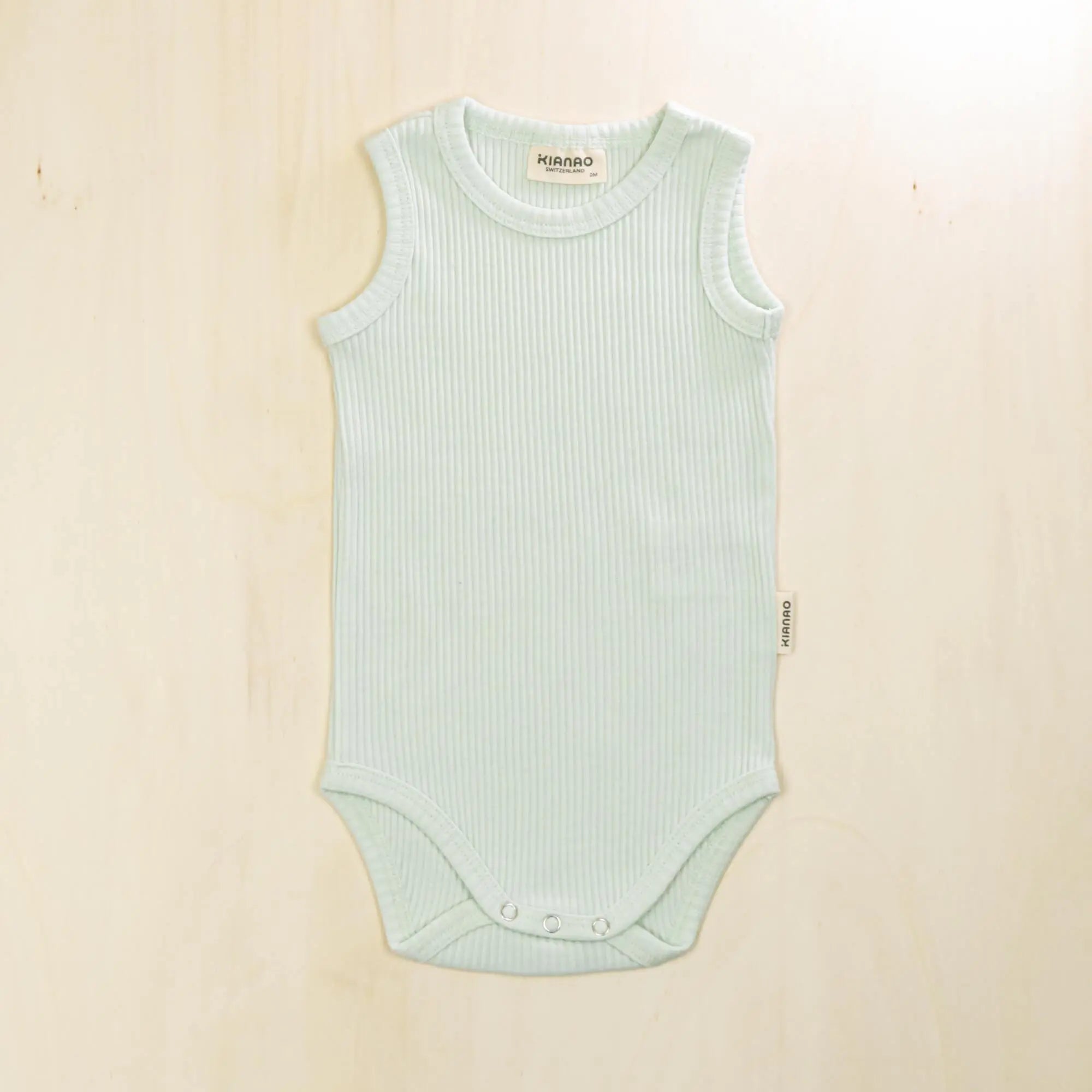 pale turquoise organic cotton baby bodysuit with reinforced snap closures that stay secure during active play