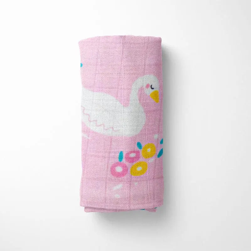 rolled pink bamboo baby blanket showing detailed swan pattern, compact for diaper bag storage