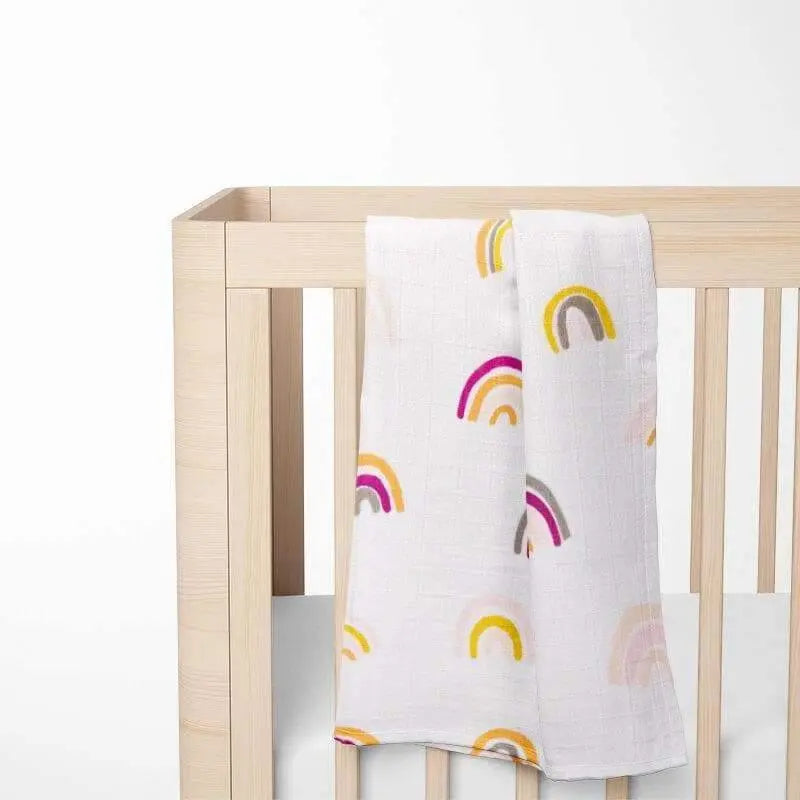 rainbow bamboo baby blanket displayed on crib, showing colorful pattern and grid texture, perfect for sensitive skin