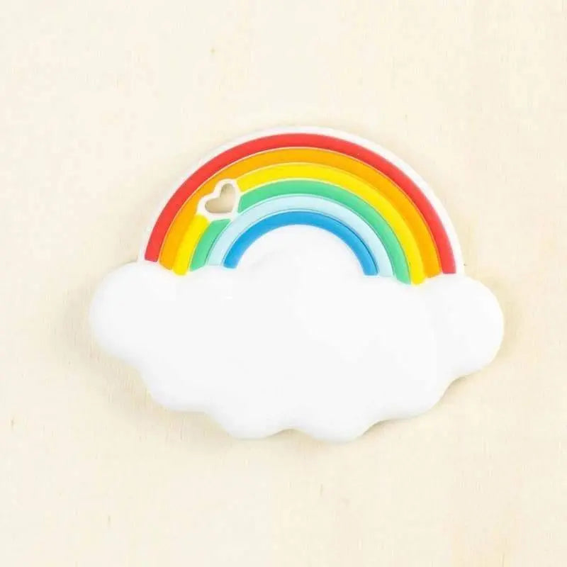colorful rainbow silicone teether with white cloud base featuring textured surfaces for baby gum relief