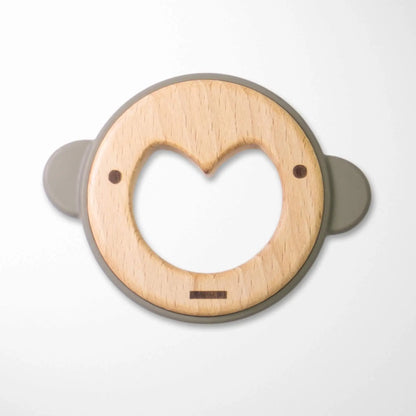 sage green silicone ear wooden monkey teether with heart-shaped center and smooth beechwood surface for soothing sore gums