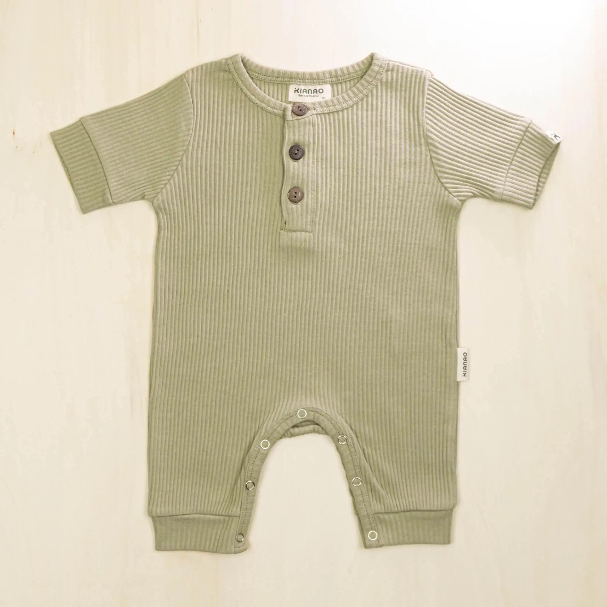sage green organic cotton baby henley romper with short sleeves ideal for warm weather comfort
