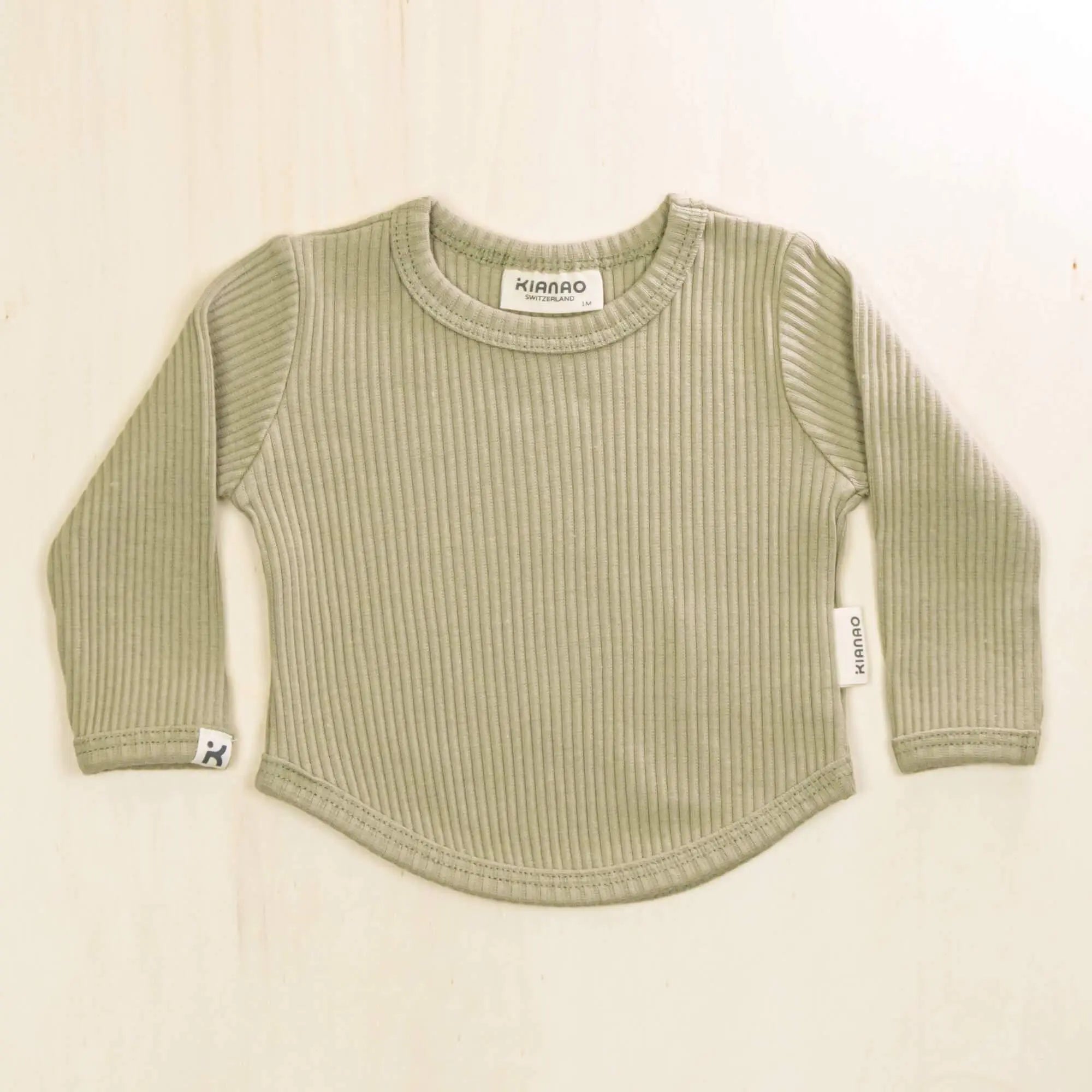 sage green organic cotton baby shirt with ribbed texture and long sleeves, stretchy and soft for sensitive skin
