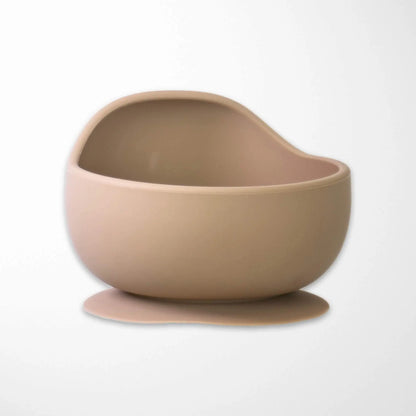 sand color silicone baby bowl with powerful suction base that prevents tipping and spills during active mealtimes