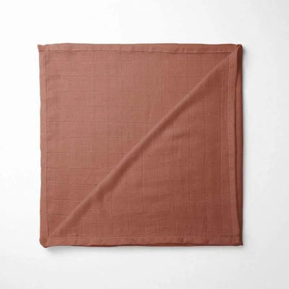 folded terracotta bamboo baby blanket showing rich earthy color and soft texture, perfect for sensitive skin