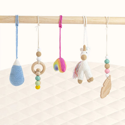 Front view of Unicorn Play Gym with all crochet toys visible including unicorn figure and colorful elements