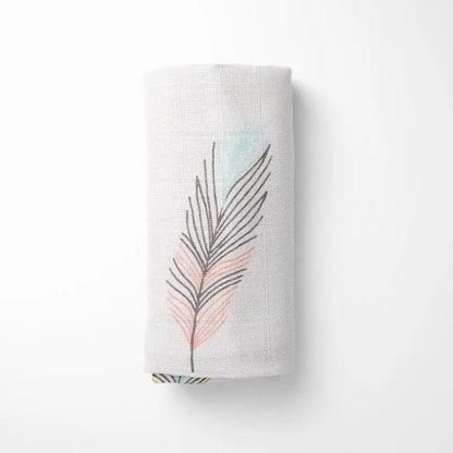 rolled bamboo baby blanket showing detailed watercolor leaf pattern, compact for travel and storage
