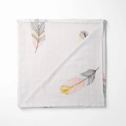 white bamboo baby blanket with watercolor leaf pattern in pastel colors, organic and ultra-soft for sensitive skin