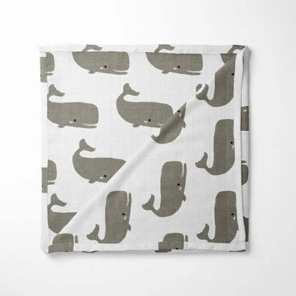 white organic cotton baby blanket with gray whale pattern double-layer design displayed flat showing marine animal print