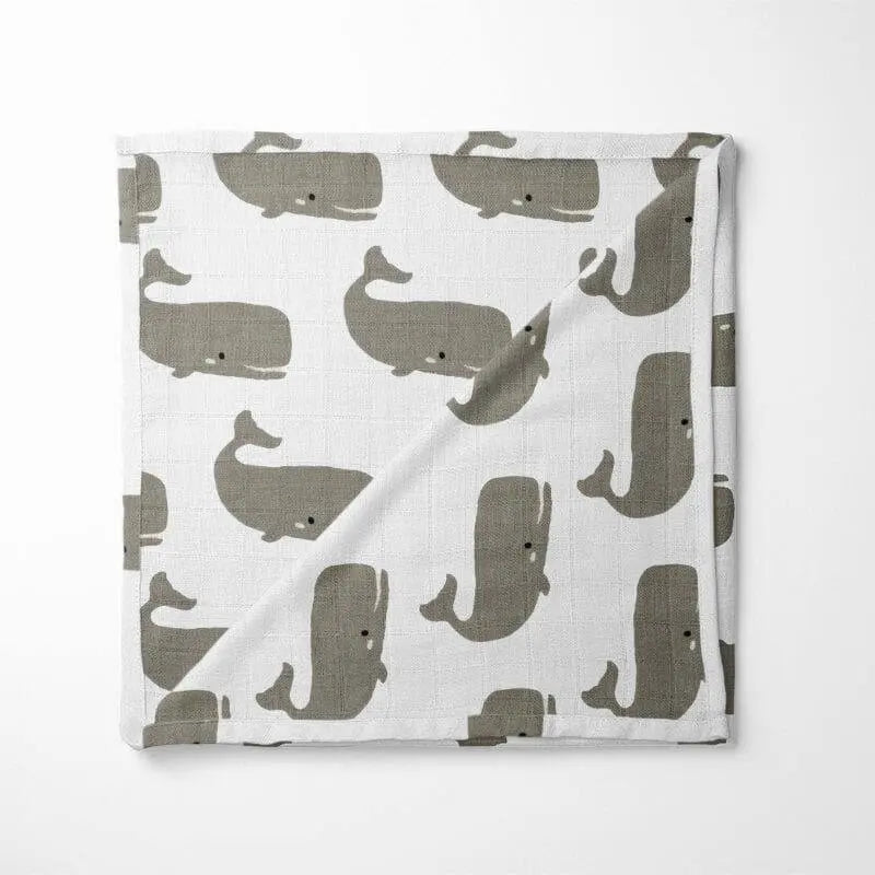 white organic cotton baby blanket with gray whale pattern double-layer design displayed flat showing marine animal print