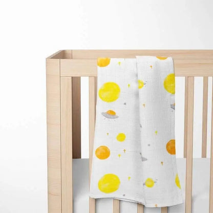 white bamboo baby blanket with planet design displayed on crib showing perfect size for infant sleep